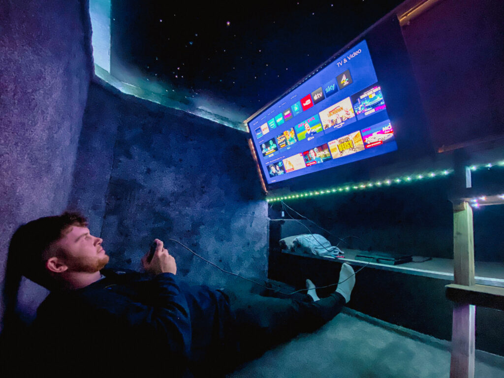Person relaxing with gaming and TV