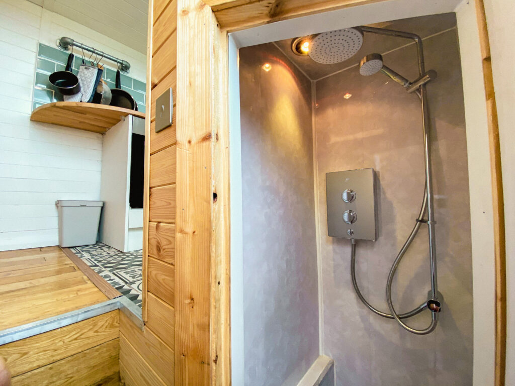 Compact shower in stylish campervan interior.