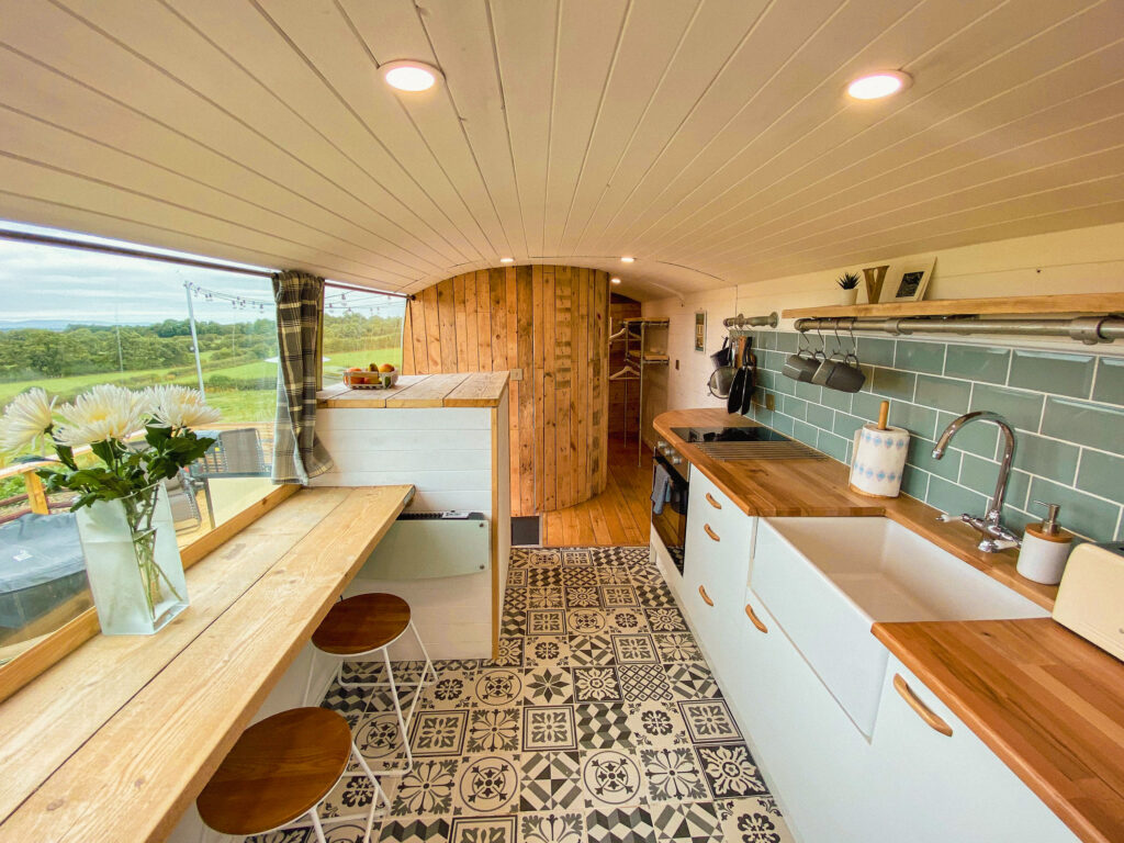Cozy campervan interior with kitchen.