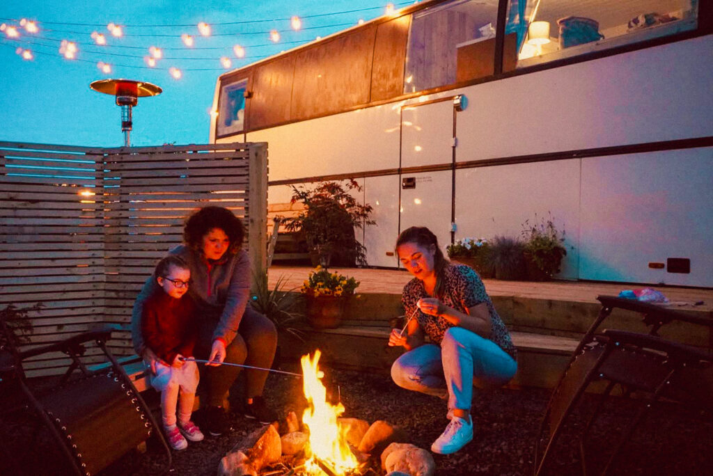 Friends roasting marshmallows by fire